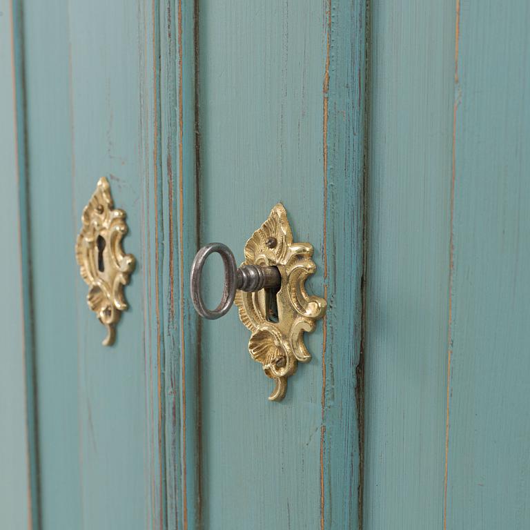 A corner display cabinet, 19th century with a later base.
