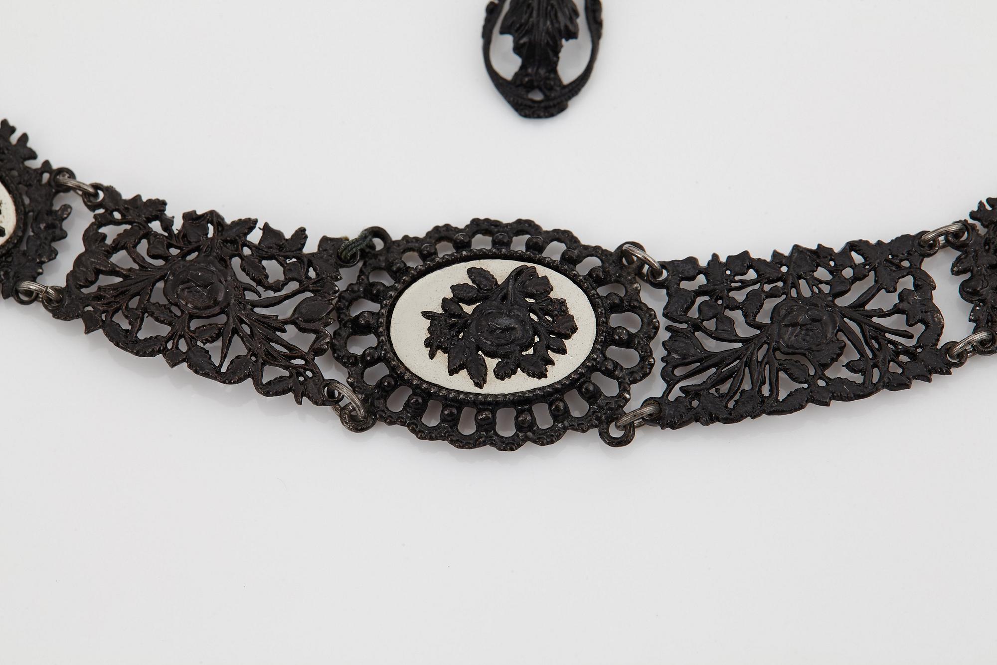 A Berlin steel and iron parure comprising a necklace, two bracelets and a brooch.