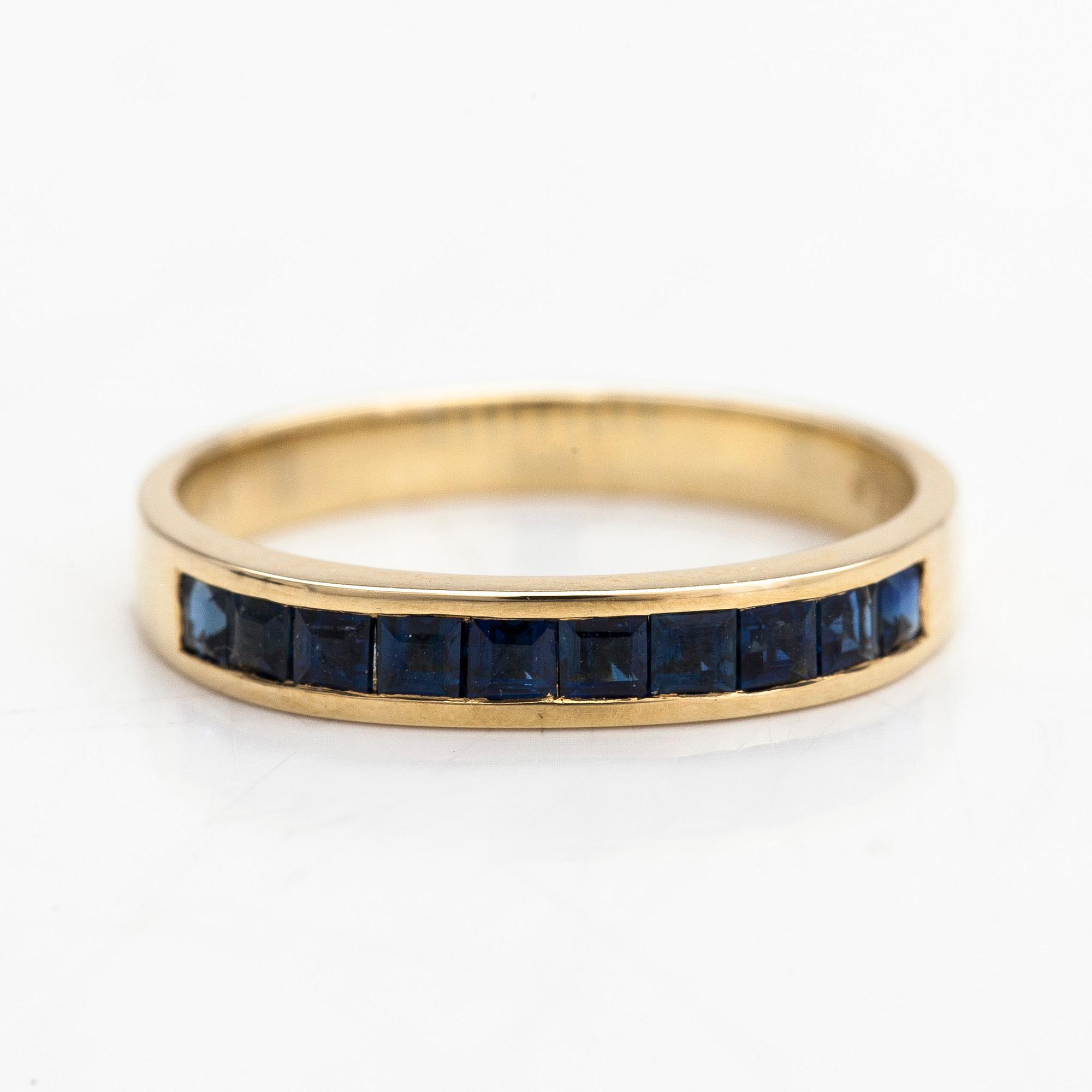 A half-eternity 14K gold ring with sapphires.