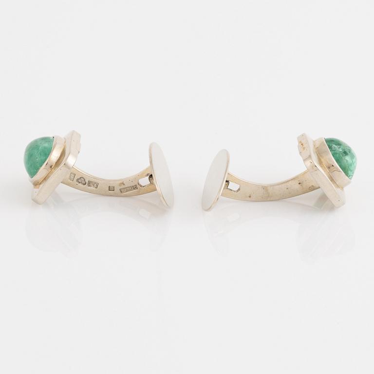 18K white gold and cabochon cut emerald cufflinks.