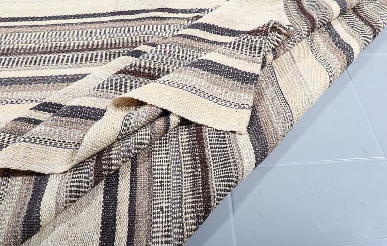 A FLATWEAVE RUG, 338 x 240 cm.