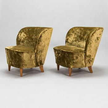 A pair of mid-20th-century armchairs.