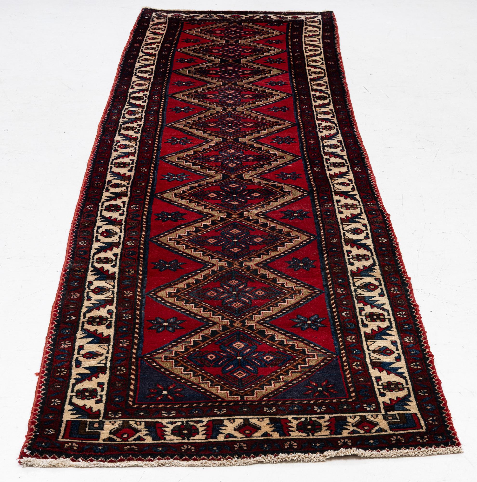 An oriental runner, c. 395 x 100 cm.