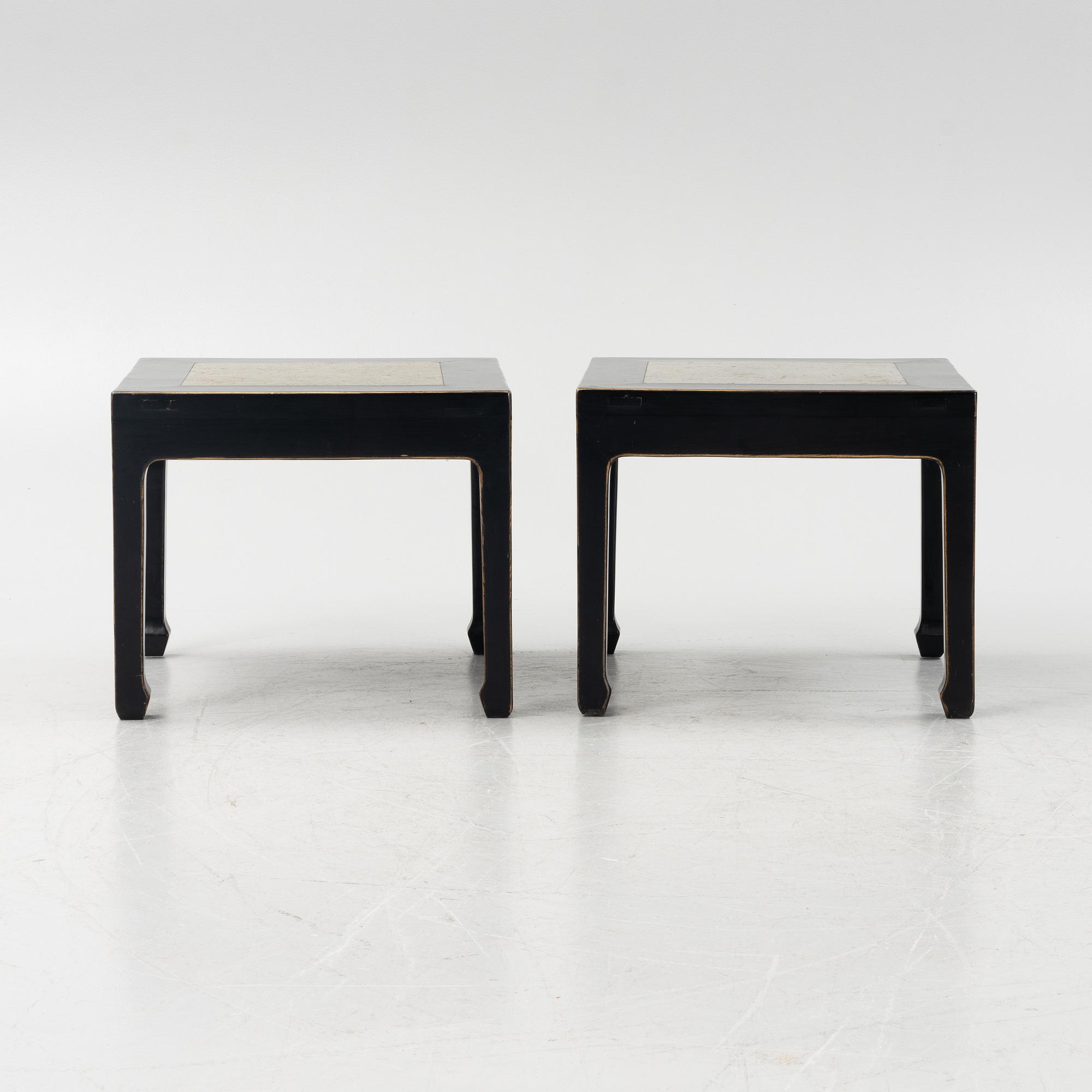 A pair of blac painted side tables with stone tops.