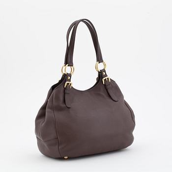 PRADA, a brown leather shoulder bag.