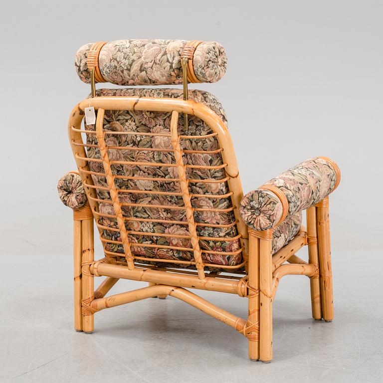 A set of two garden sofas, an armchair and a glass table, later part of the 20th Century.