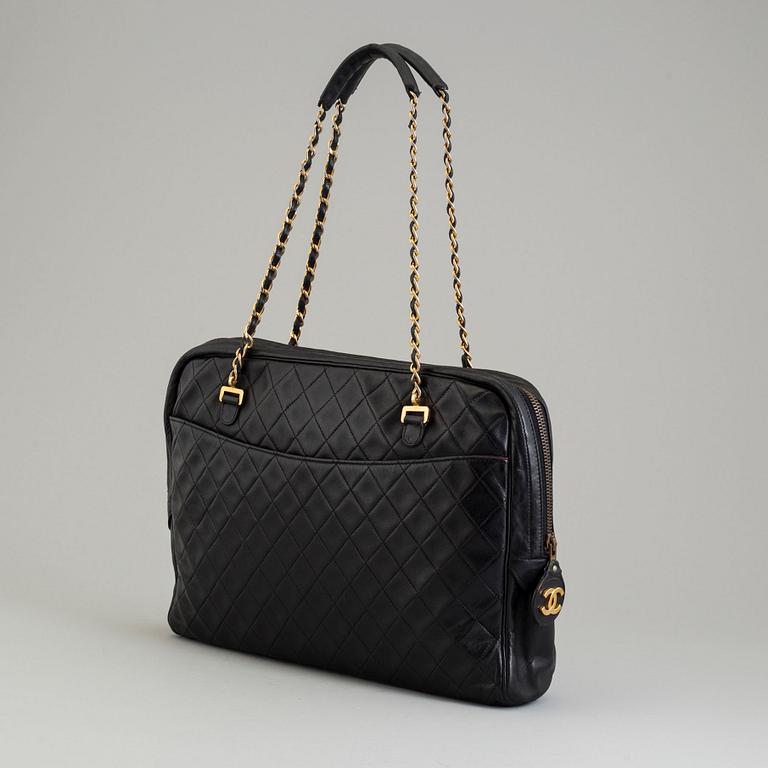 a CHANEL black leather bag.