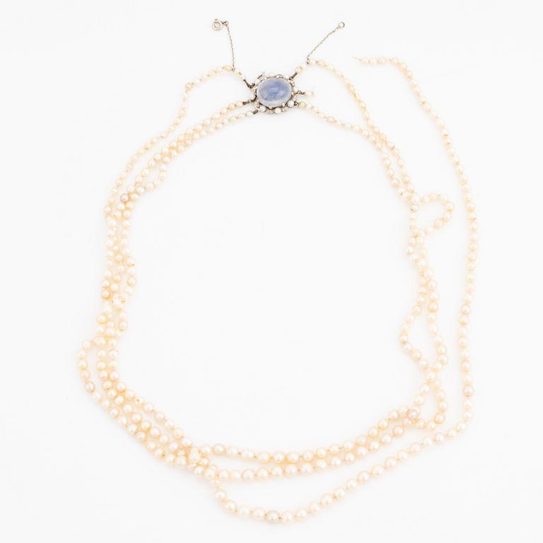 Three strand pearl necklace, clasp with cabochon cut sapphire.