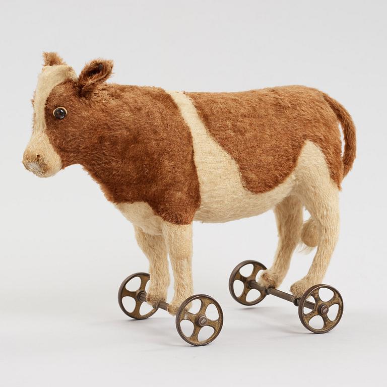 a STEIFF cow on wheels, Germany ca 1910.