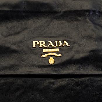 A black leather bag/clutch by Prada.