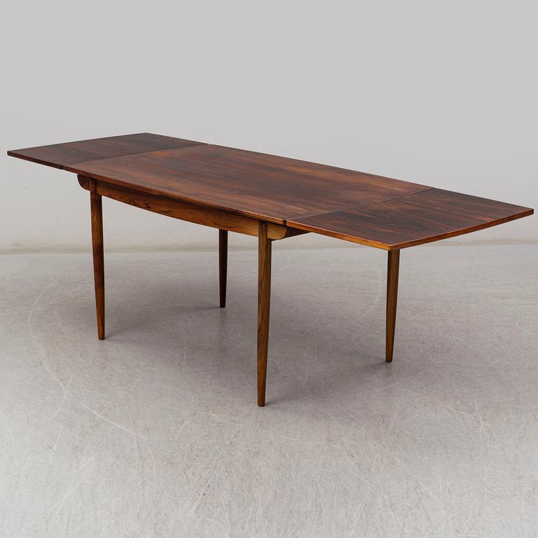 A 1950's/60's rosewood dinner table with four chairs, Denmark.