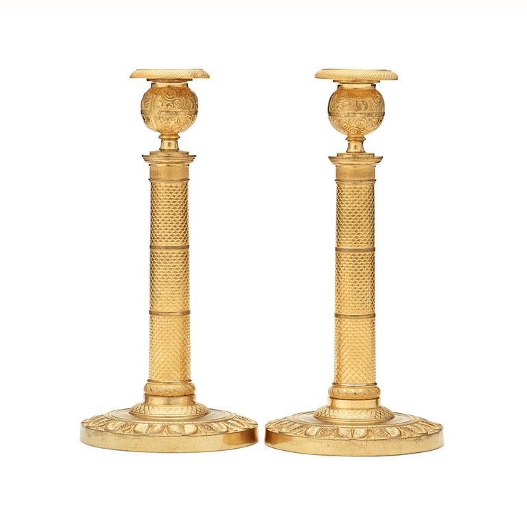 A pair of French Empire early 19th century candlesticks.