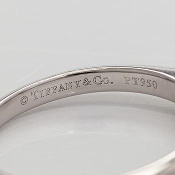 Tiffany & Co, a platinum solitaire ring with a brilliant-cut diamond.