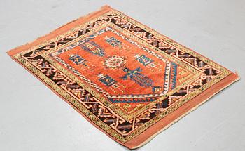 A rug, an antique Anatolian, ca 128 x 104,5-108 cm (as well as ca 8-10 cm flat weave at the ends).