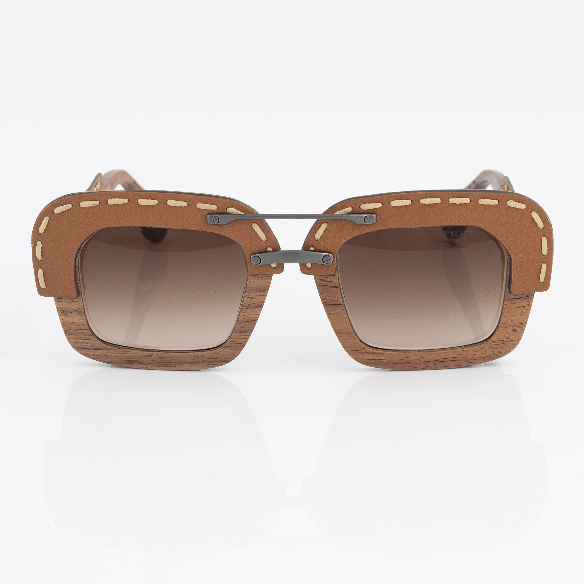 Prada, a pair of wood and leather sunglasses.