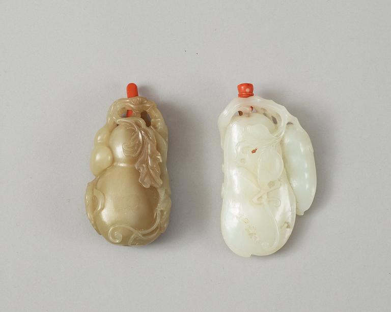 Two Chinese nephrite snuff bottles with stoppers.