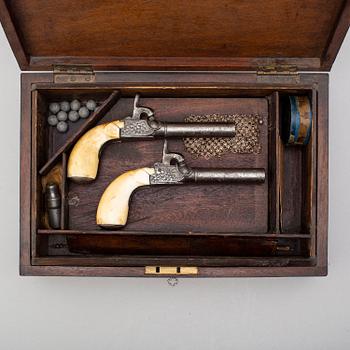 A mid 19th century Belgian rifled percussion pistols with ivory butts in a case.