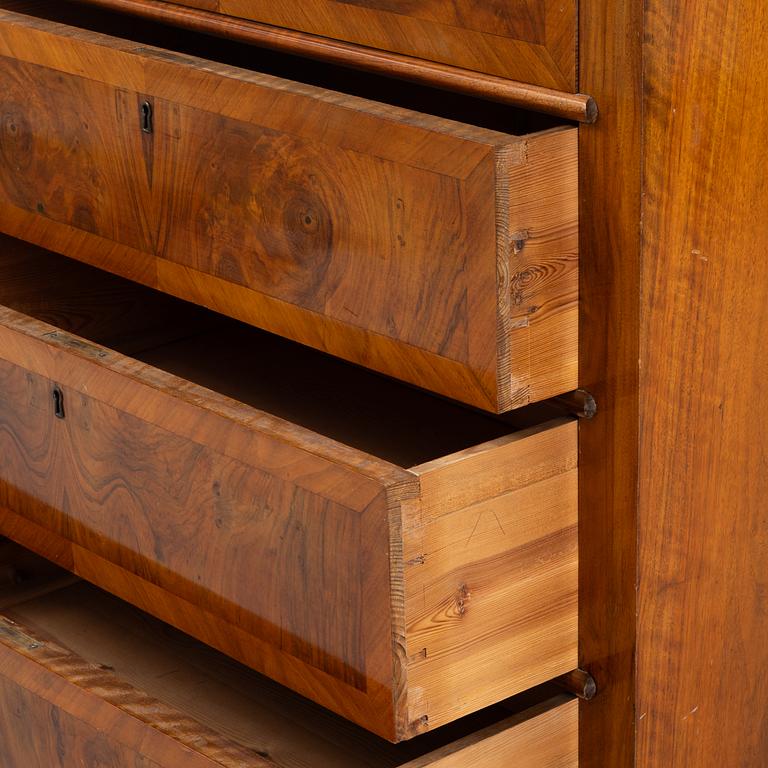 A walnut-veneered dresser, around 1900.