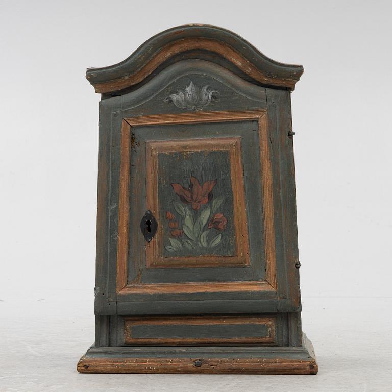 A painted wall cabinet, 19th century.
