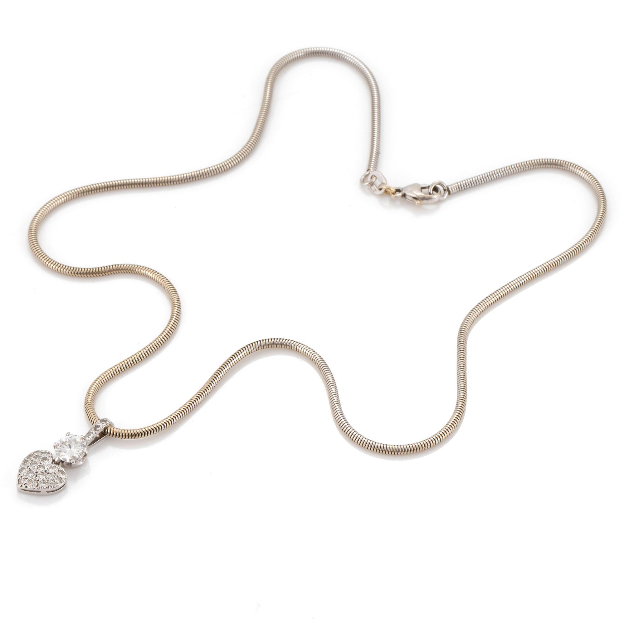 A chain and a pendant set with eight-cut and a round, brilliant-cut diamond.