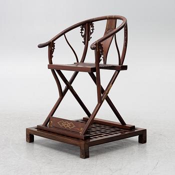 A Chinese hardwood folding chair, 20th century.
