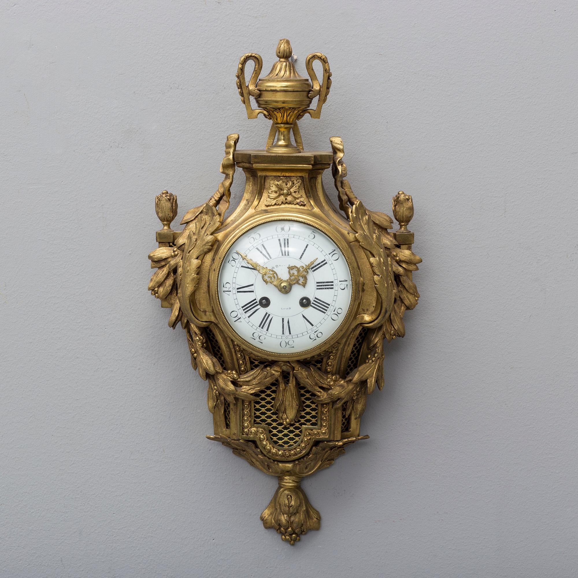 A brass wall clock marked A.W. Bruuns eftr, Lund from around year 1900.