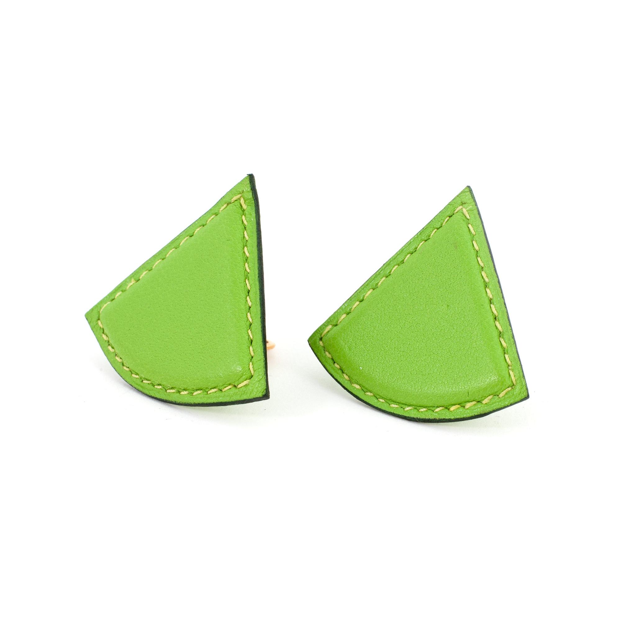 HERMÈS, a pair of green leather clip earings from the 1990s.