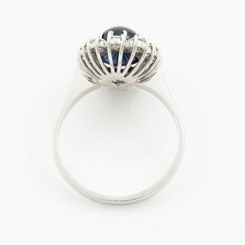 Ring in 18K white gold with a cabochon-cut sapphire and brilliant-cut diamonds.