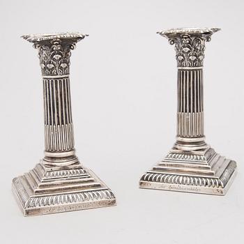 A pair of sterling silver candlesticks, William Hutton & Sons Ltd, London 1895.