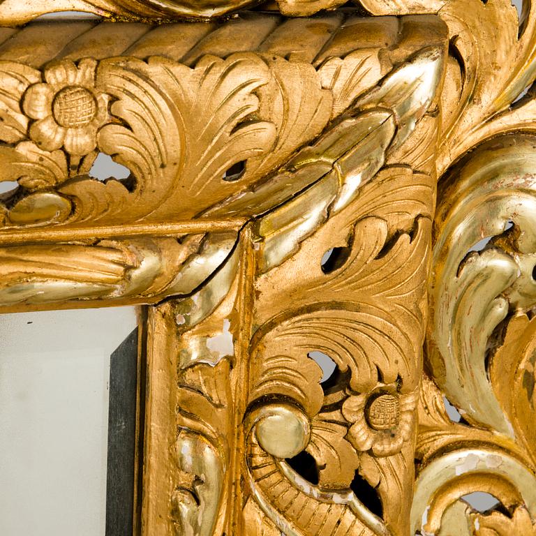 A MIRROR, Baroque style, circa 1900, gilt wood.