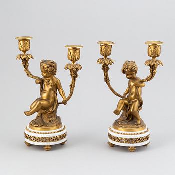 A pair of Louis XVI style gilt bronze and marble two light candelabras, circa 1900.