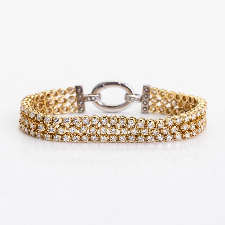 An 18K gold 3-strand tennisbracelet, set with brilliant-cut diamonds totalling approximately 10.54 ct.