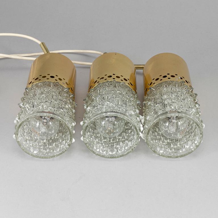 Three brass and glass pendant lights, 1960's.