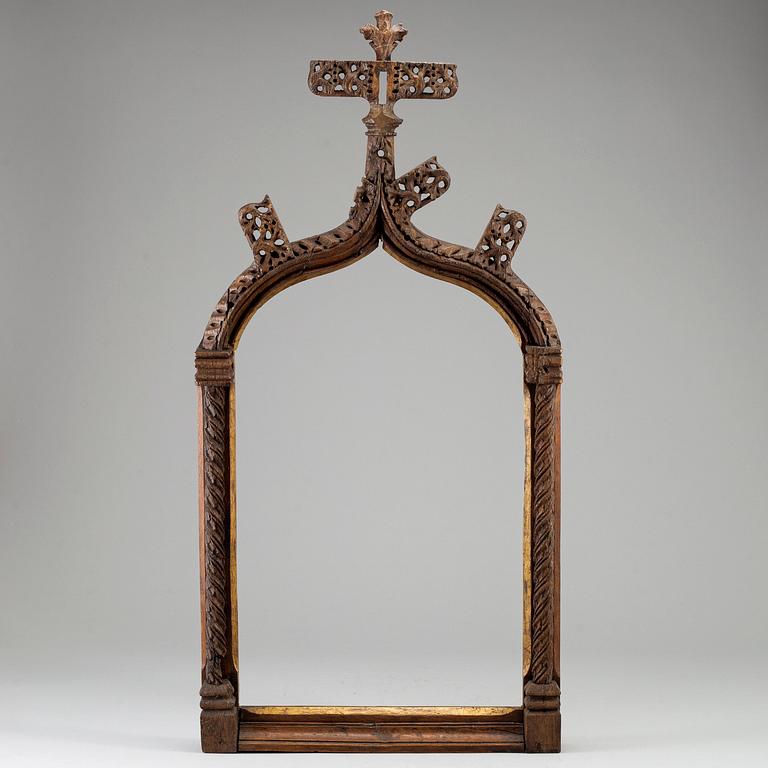 A possibly 16th century carved dark wood picture frame.