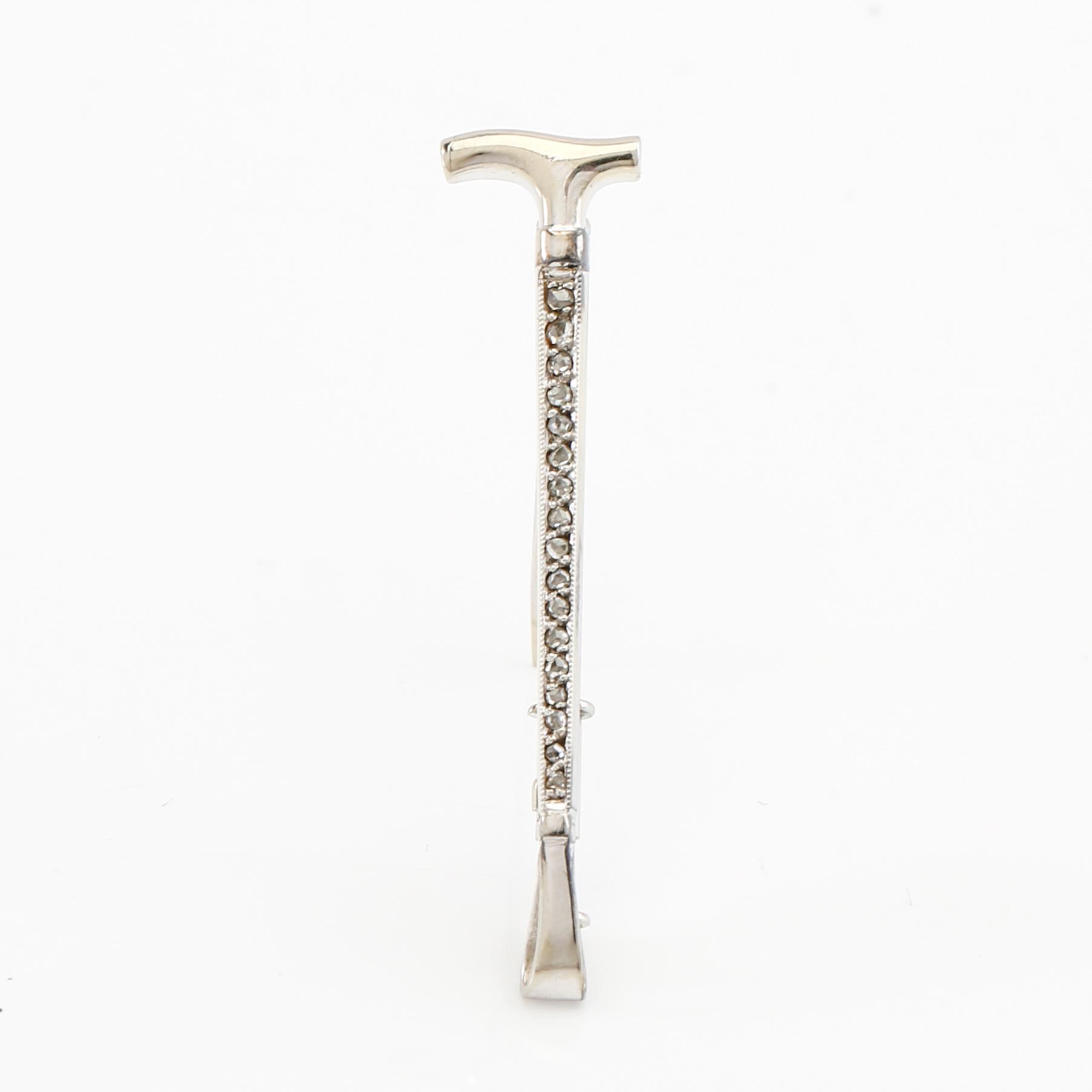 Brooch in 18K white gold shaped like a riding crop with rose-cut diamonds, G. Dahlgren & Co Malmö 1944.