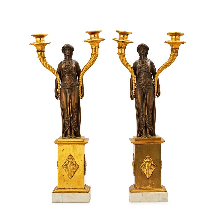 A pair of late Gustavian circa 1800 gilt and patinated bronze two-light candelabra.