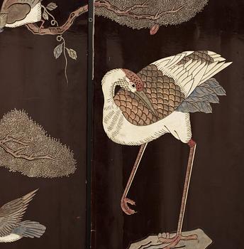 A coromandel black-lacquer four panel screen, Qing Dynasty (1644-1912).