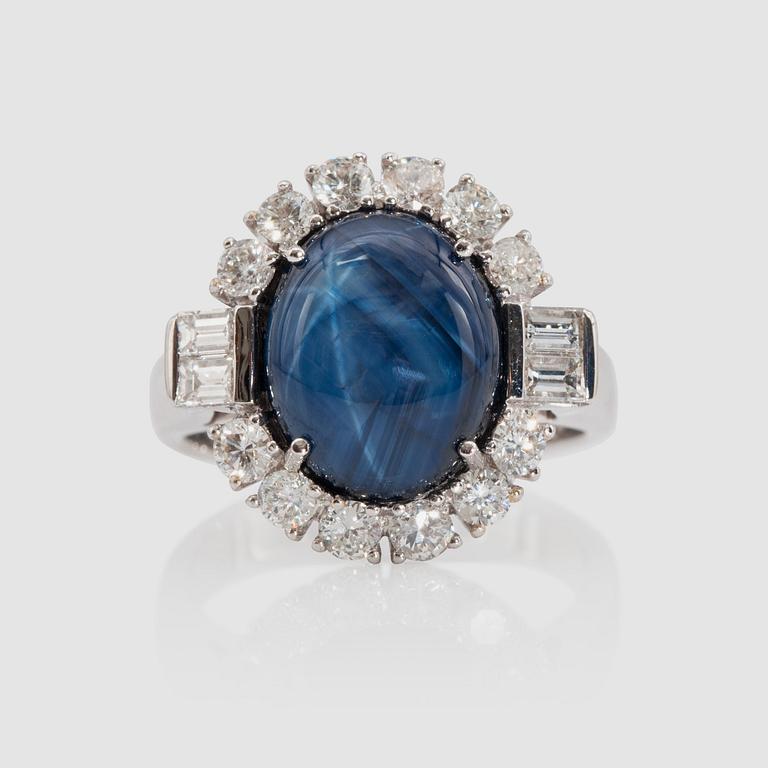 A 6.81 cts star sapphire and brilliant-cut diamond ring. Total carat weight of diamonds 1.05 cts.