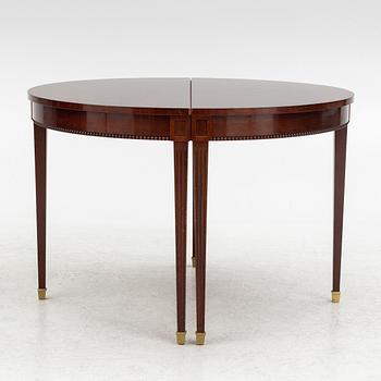 An Empire style dining table and ten chairs, second half of the 20th Century.
