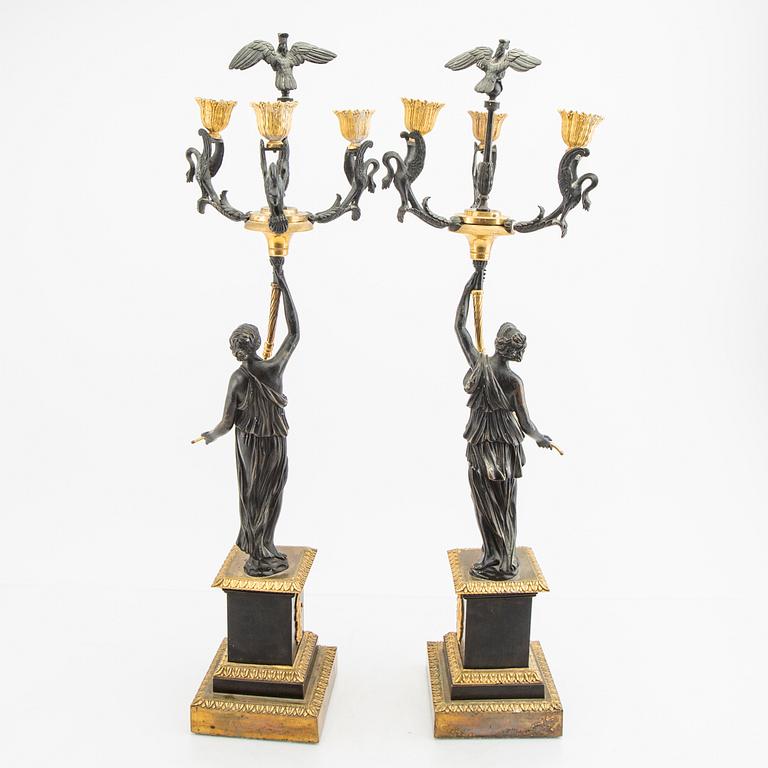 A pair (nearly) of Empire style candelabras later part of the 19th century.