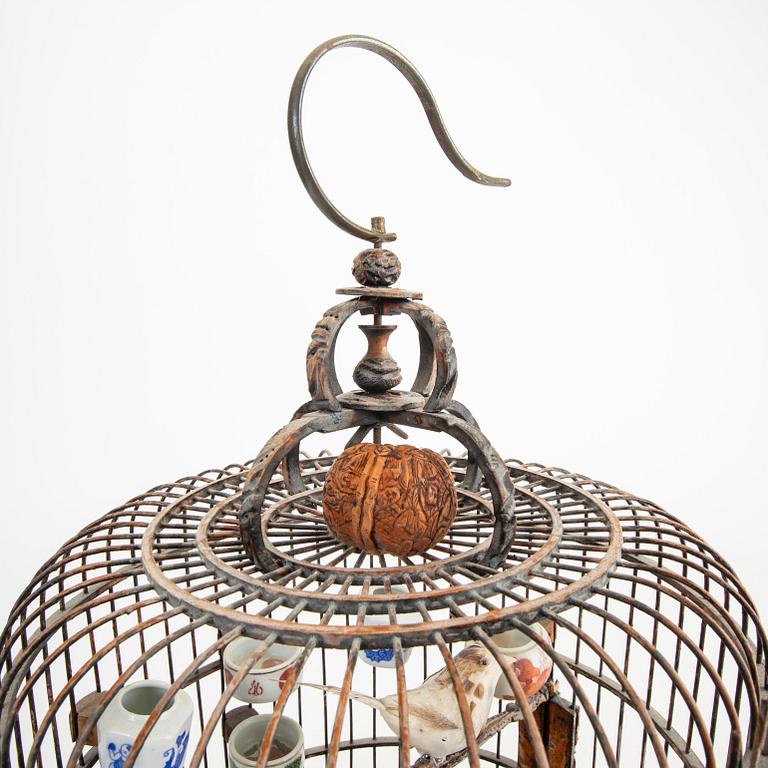 A Chinese bird cage with bird feeders, 20th Century.