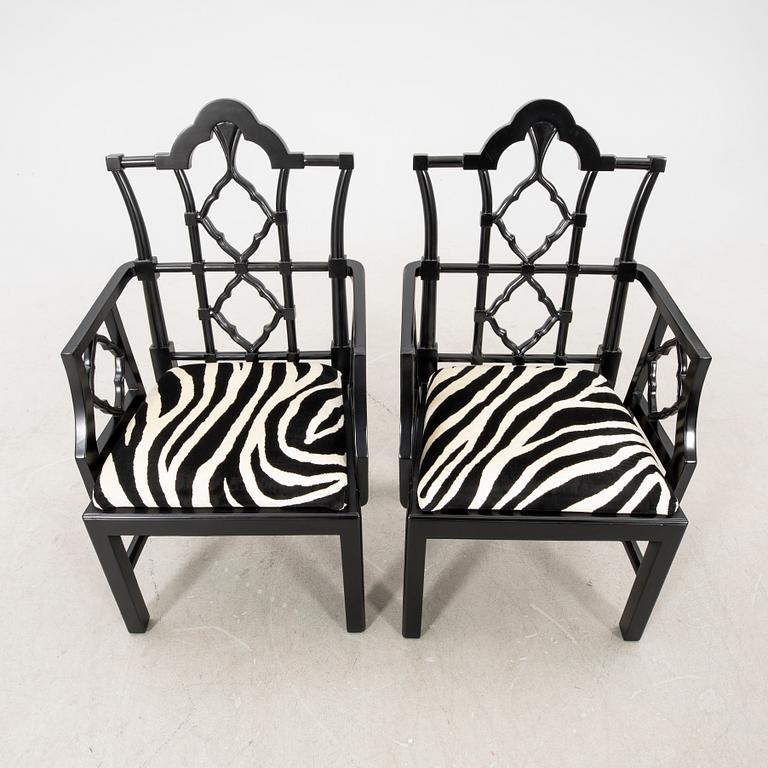 A pair of modern Eichholtz armchairs.
