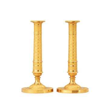 517. A pair of French Empire early 19th century candlesticks.