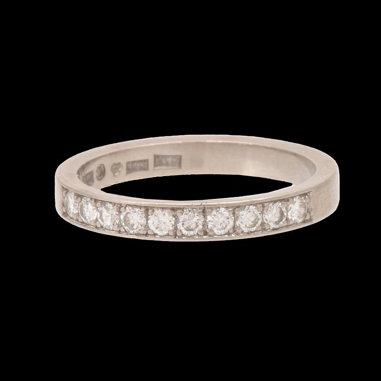 An 18K white gold half eternity ring set with round brilliant-cut diamonds.