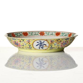 A yellow-ground famille rose 'lotus' dish, Qing dynasty, Jiaqing red seal mark and of the period (1796-1820).