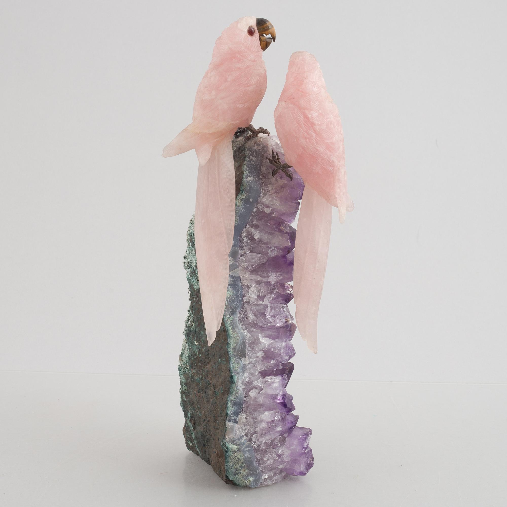 Sculpture, carved stone, birds on a quartz cliff.