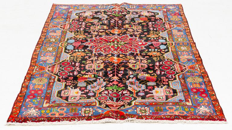An oriental rug, ca 234 x 134-144 cm.
