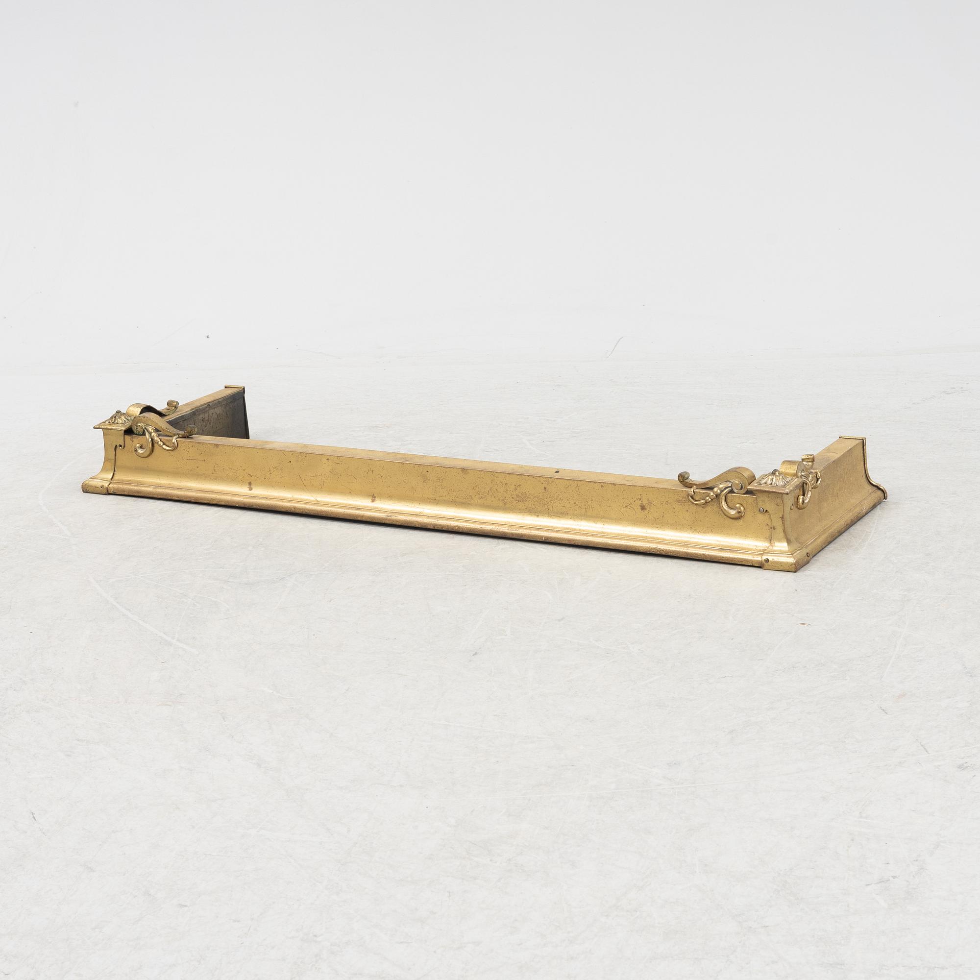 A brass fire guard, around 1900.