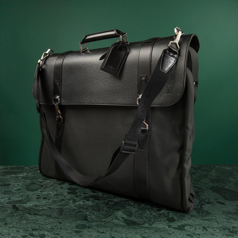 A Garment bag by Louis Vuitton.
