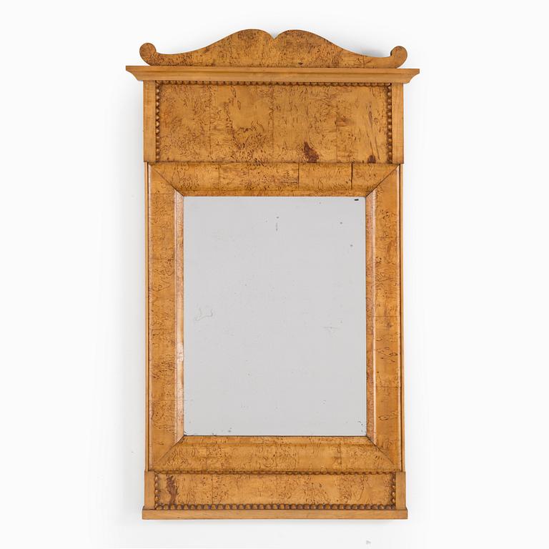 A birch veneered Swedish mirror, late empire, mid 19th Century.